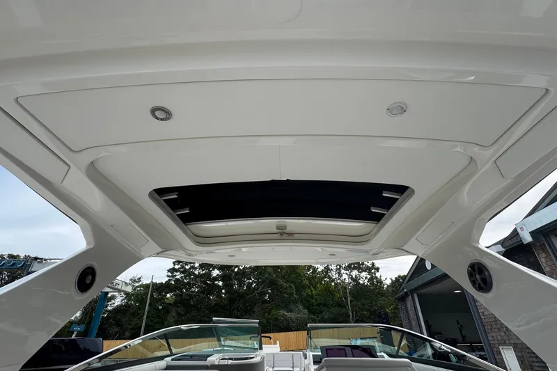 Slide: The Image of 2021 Sea Ray 310 SLX boat interior with open sunroof and sleek design. - 32