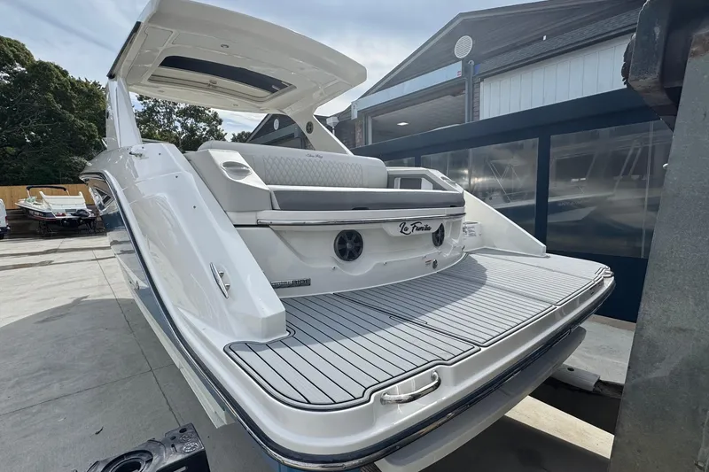 Slide: The Image of 2021 Sea Ray 310 SLX boat with sleek design, docked outdoors. - 4