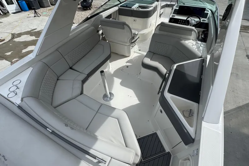 Slide: The Image of 2021 Sea Ray 310 SLX boat interior with luxurious seating and modern dashboard. - 9