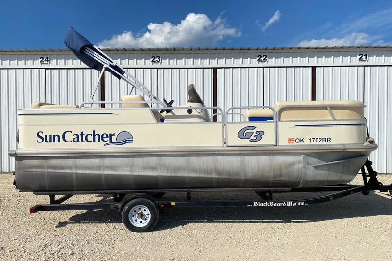 The Image of 2004 G3 SunCatcher LX 20 Cruise pontoon boat on trailer, parked outdoors. - 0