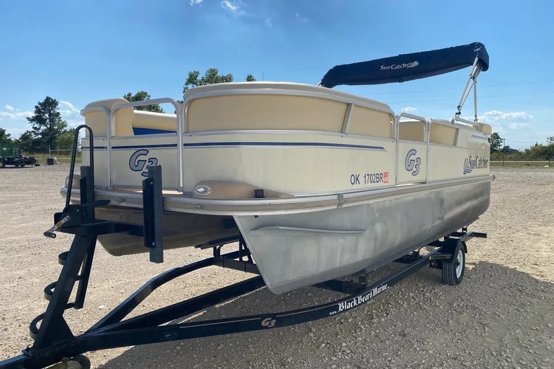 Slide: The Image of 2004 G3 SunCatcher LX 20 Cruise pontoon boat on trailer, parked outdoors. - 2