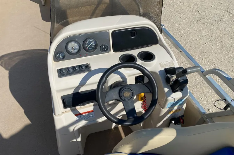 Slide: The Image of 2004 G3 SunCatcher LX 20 Cruise boat dashboard with steering wheel and controls. - 5