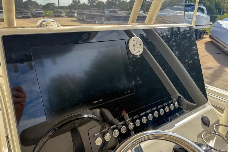 Slide: The Image of 2021 Key West 219 FS boat dashboard with Garmin display and control panel. - 10