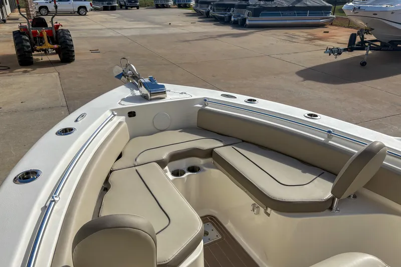 Slide: The Image of 2021 Key West 219 FS boat interior with cushioned seating and cup holders. - 12