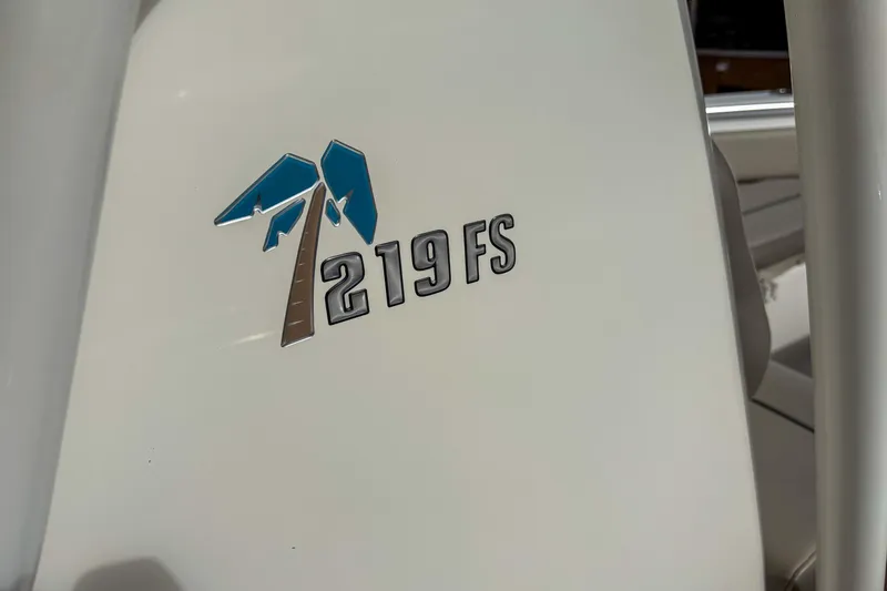 Slide: The Image of 2021 Key West 219 FS logo on boat surface, featuring a palm tree design. - 13