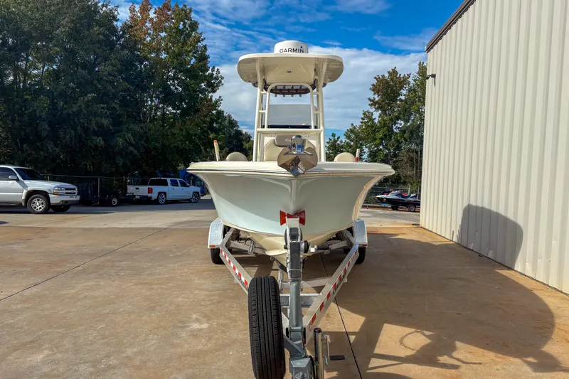 Slide: The Image of 2021 Key West 219 FS boat on trailer, parked outdoors near a building. - 4
