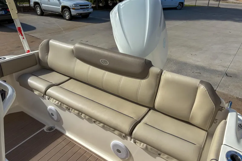 Slide: The Image of 2021 Key West 219 FS boat with beige seating and visible engine. - 6
