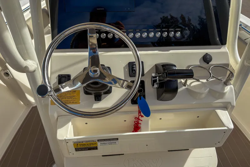 Slide: The Image of Steering console of 2021 Key West 219 FS boat with controls and display. - 9