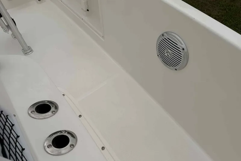 Slide: The Image of 2026 Bayliner Trophy T18 boat interior with speaker and rod holders. - 10