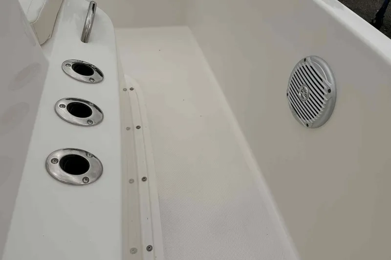 Slide: The Image of 2026 Bayliner Trophy T18 boat interior with rod holders and speaker. - 4