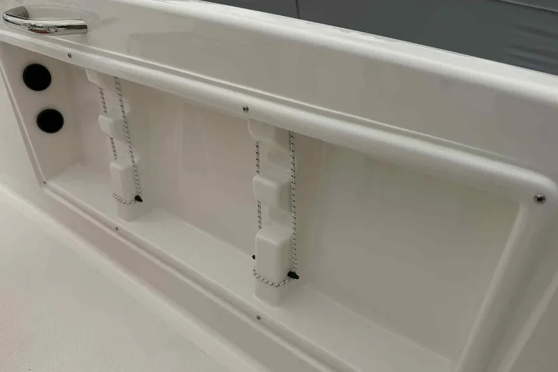 Slide: The Image of 2026 Bayliner Trophy T18 boat interior detail with white panel and chrome handle. - 7