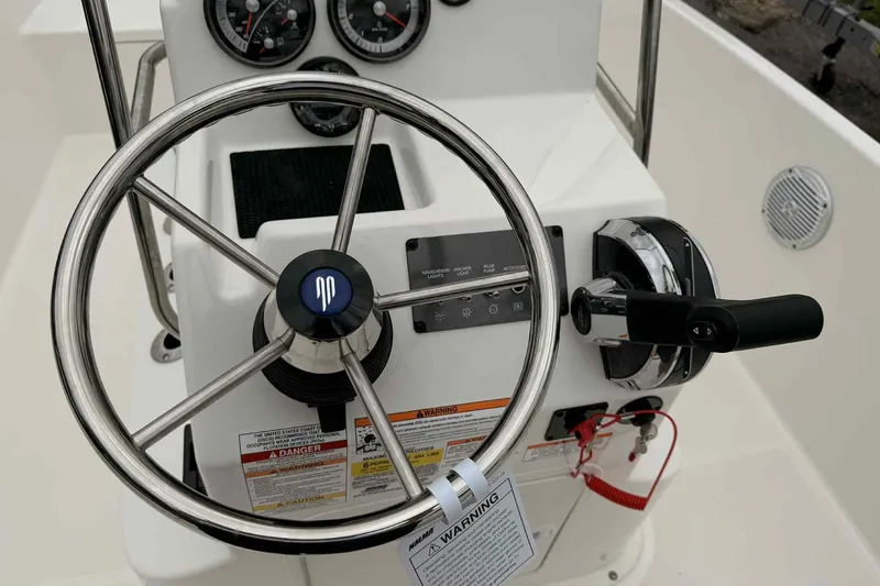 Slide: The Image of Steering wheel and controls of 2026 Bayliner Trophy T18 boat cockpit. - 9