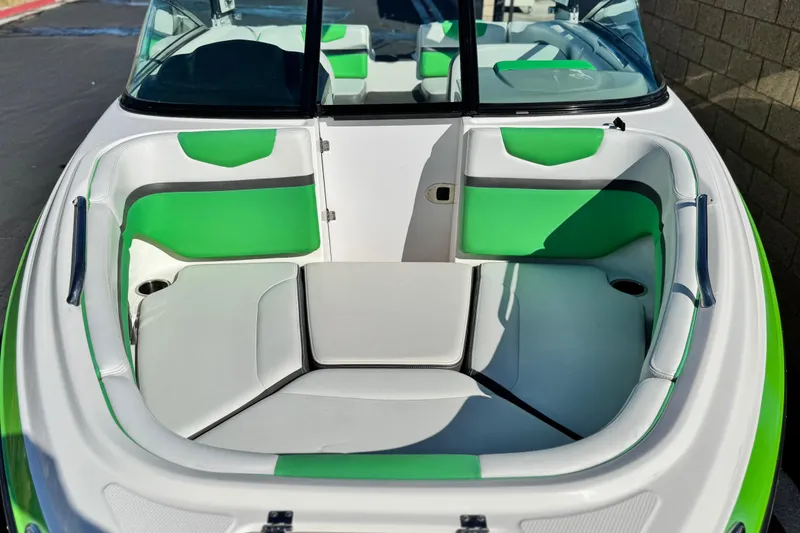 Slide: The Image of 2015 Chaparral Vortex 203 VRX boat interior with green and white seating. - 12