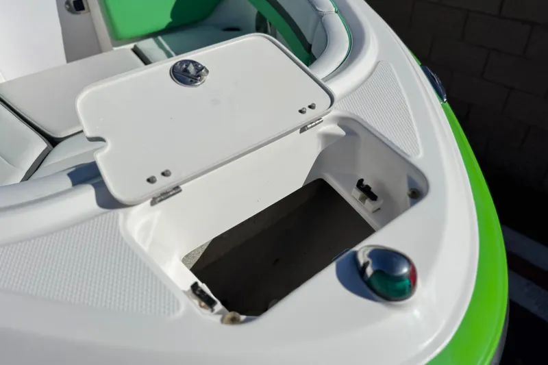Slide: The Image of 2015 Chaparral Vortex 203 VRX boat storage compartment with open hatch and green seating. - 14
