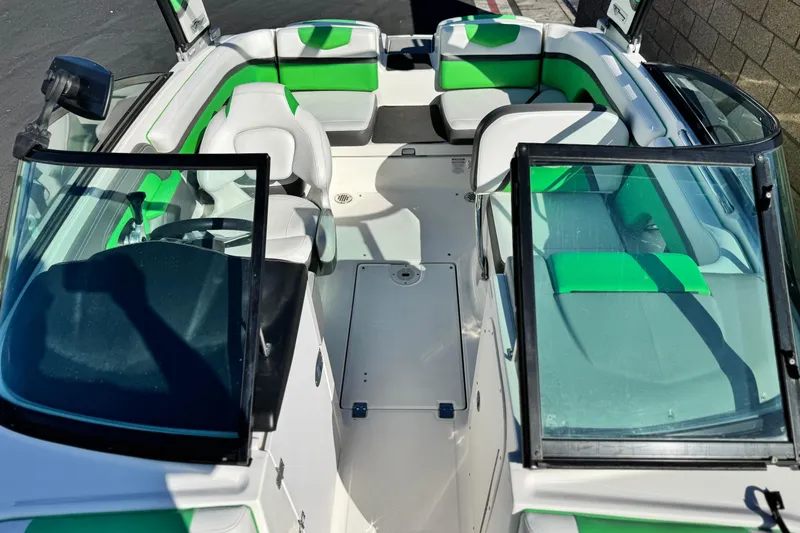 Slide: The Image of 2015 Chaparral Vortex 203 VRX boat interior with green and white seating. - 18