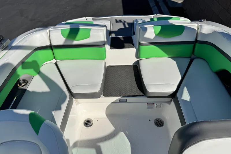 Slide: The Image of 2015 Chaparral Vortex 203 VRX boat interior with green and white seating. - 19