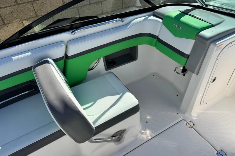Slide: The Image of 2015 Chaparral Vortex 203 VRX boat interior with green and gray seating. - 22