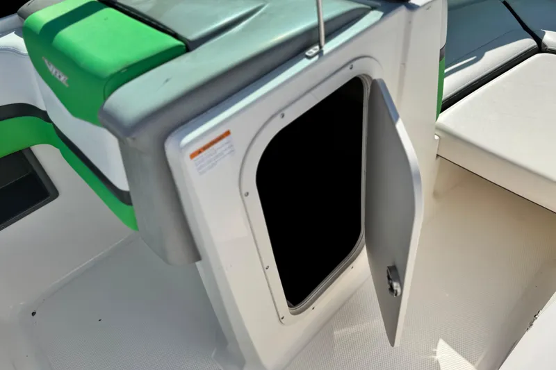 Slide: The Image of 2015 Chaparral Vortex 203 VRX boat storage compartment with open door. - 25