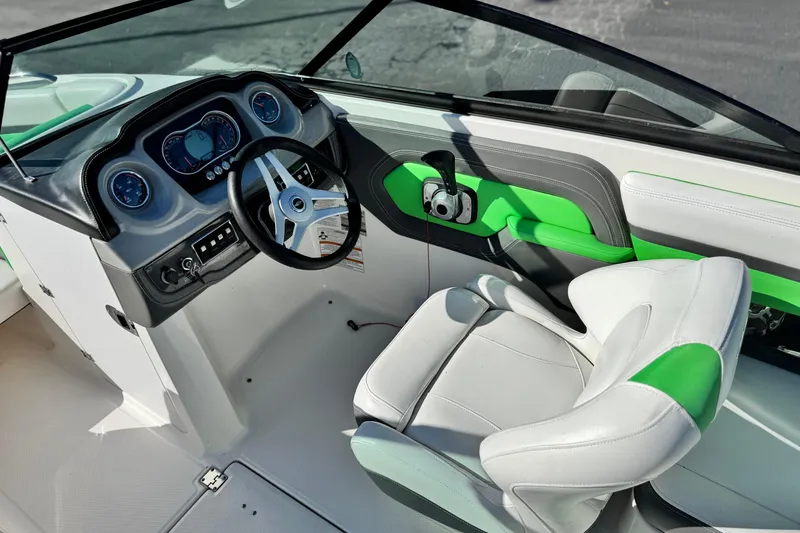 Slide: The Image of 2015 Chaparral Vortex 203 VRX boat interior with green accents and modern dashboard. - 27