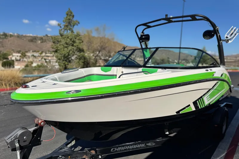 Slide: The Image of 2015 Chaparral Vortex 203 VRX boat with green accents on a trailer. - 3
