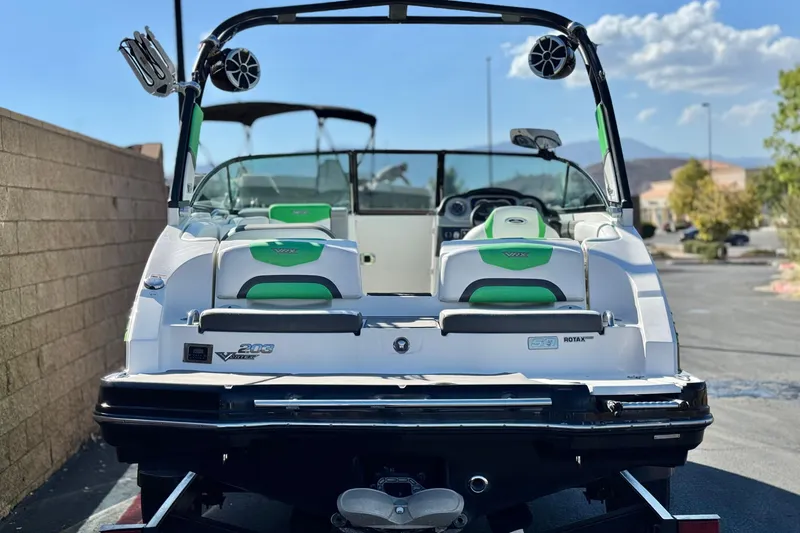 Slide: The Image of 2015 Chaparral Vortex 203 VRX boat, rear view, green and white seating, parked outdoors. - 4