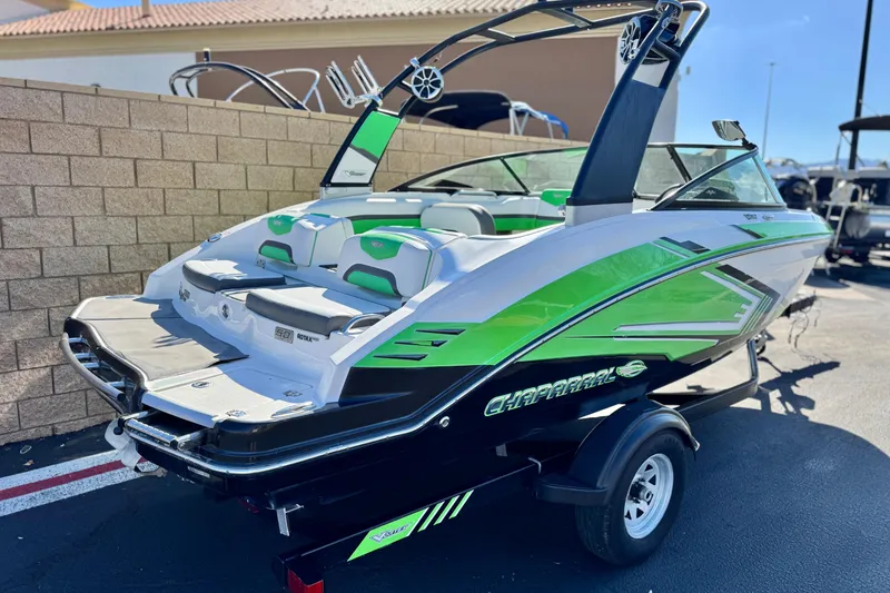 Slide: The Image of 2015 Chaparral Vortex 203 VRX boat with vibrant green accents on a trailer. - 5