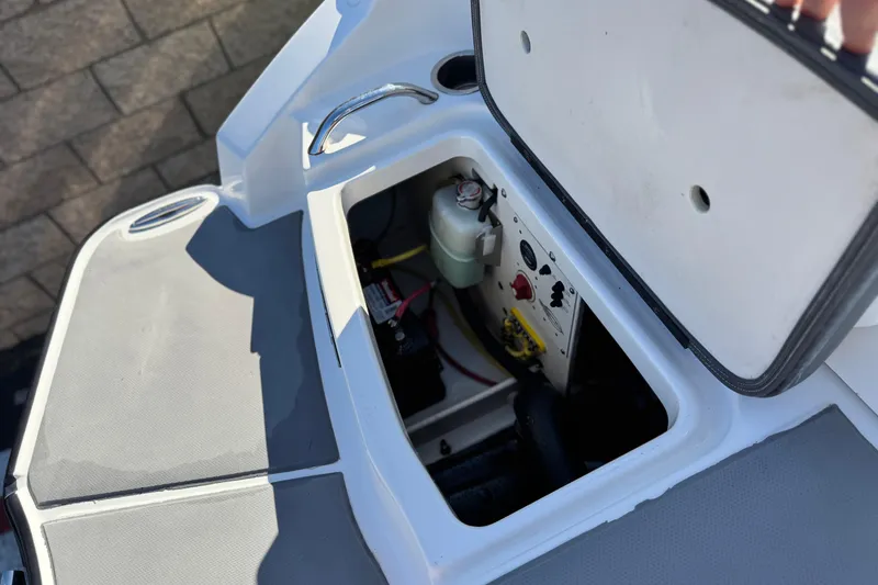 Slide: The Image of Open storage compartment in 2015 Chaparral Vortex 203 VRX boat, showing internal components. - 6