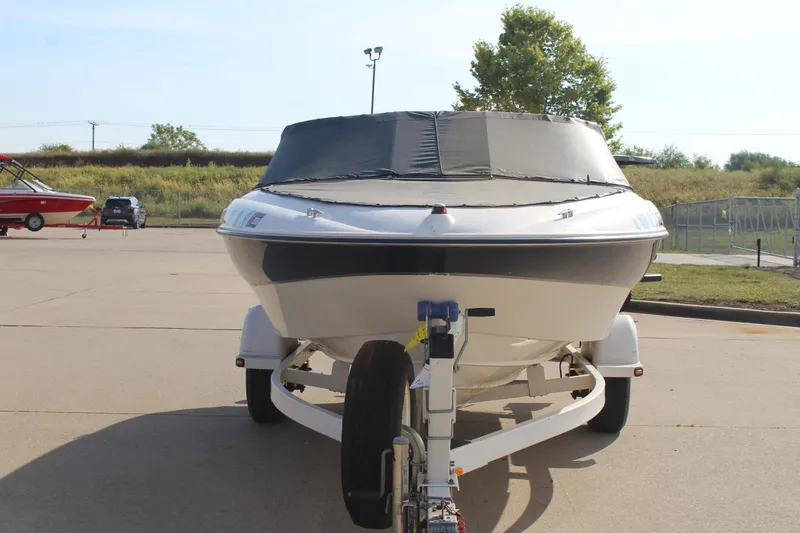 Slide: The Image of 2002 Bayliner 1950 Capri Classic boat on trailer, covered and parked outdoors. - 10