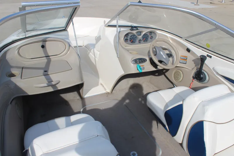 Slide: The Image of 2002 Bayliner 1950 Capri Classic boat interior with steering wheel and seating. - 16