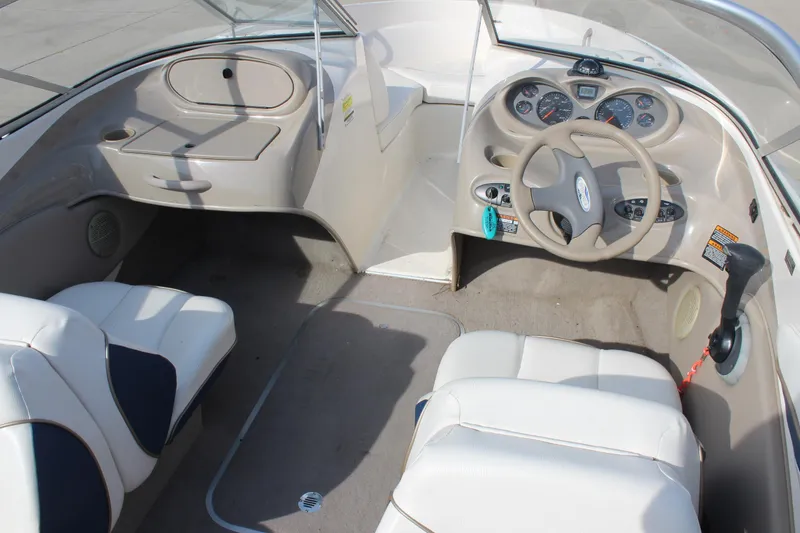 Slide: The Image of 2002 Bayliner 1950 Capri Classic boat interior with steering wheel and seating. - 17