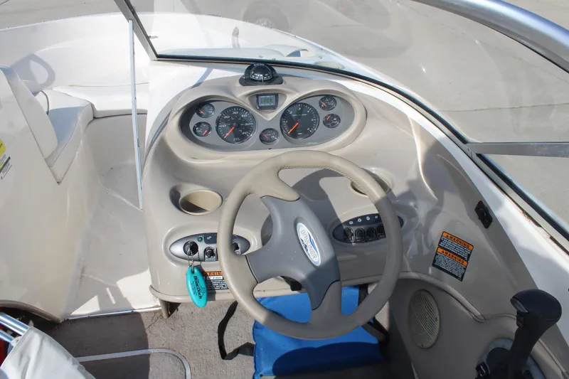 Slide: The Image of 2002 Bayliner 1950 Capri Classic boat dashboard with steering wheel and instrument panel. - 18