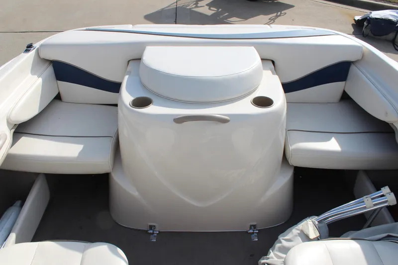 Slide: The Image of 2002 Bayliner 1950 Capri Classic boat interior with white seating and cup holders. - 21