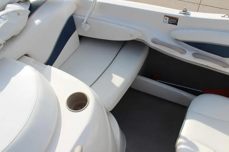 Slide: The Image of Interior seating of 2002 Bayliner 1950 Capri Classic boat, featuring white and blue upholstery. - 24