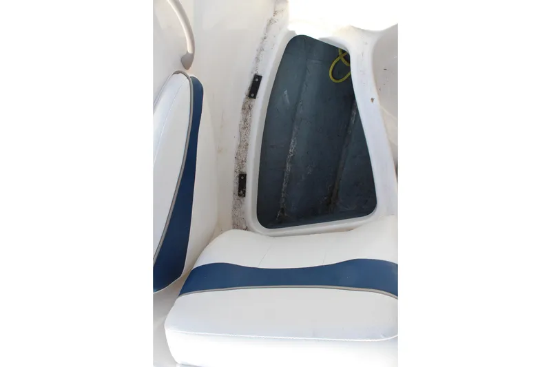 Slide: The Image of Interior view of a 2002 Bayliner 1950 Capri Classic boat seat and storage compartment. - 27