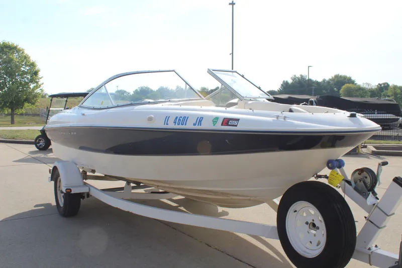 Slide: The Image of 2002 Bayliner 1950 Capri Classic boat on trailer, parked outdoors. - 3