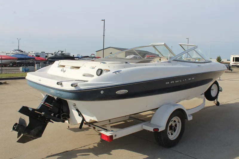 Slide: The Image of 2002 Bayliner 1950 Capri Classic boat on trailer, parked outdoors. - 5