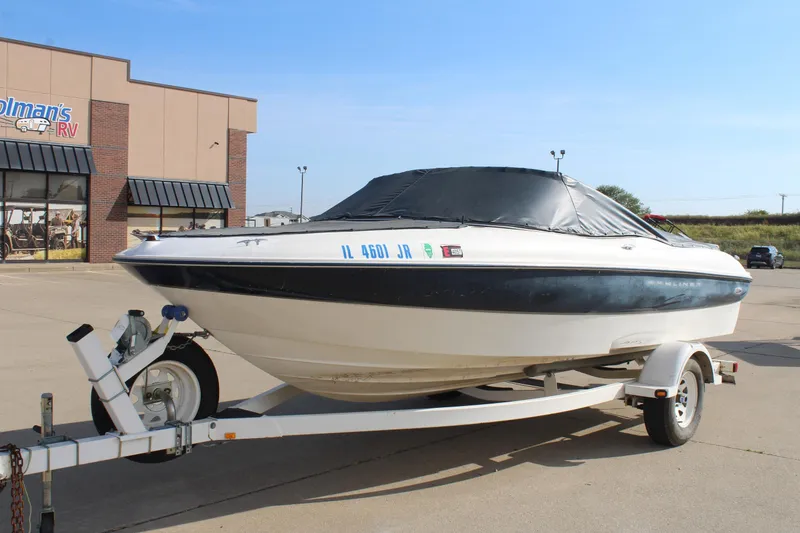 Slide: The Image of 2002 Bayliner 1950 Capri Classic boat on trailer at dealership parking lot. - 9