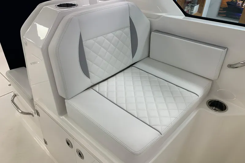 Slide: The Image of Luxurious seating on 2025 Pursuit DC 266 Dual Console boat, featuring quilted white upholstery. - 17