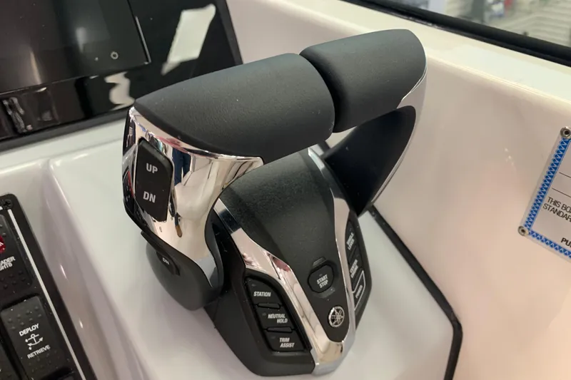 Slide: The Image of Throttle controls on a 2025 Pursuit DC 266 Dual Console boat dashboard. - 20
