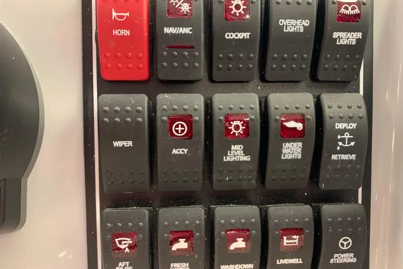 Slide: The Image of Control panel of 2025 Pursuit DC 266 Dual Console with labeled switches. - 21