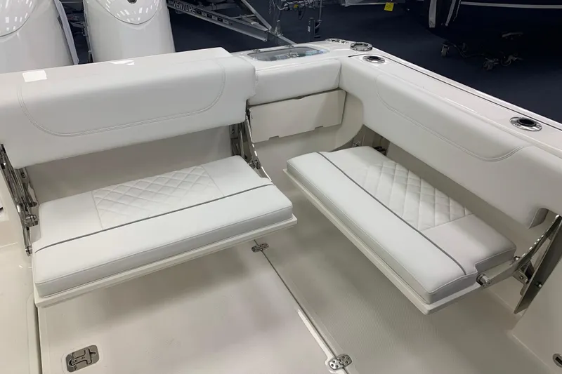 Slide: The Image of 2025 Pursuit DC 266 Dual Console boat interior with white cushioned seating. - 23