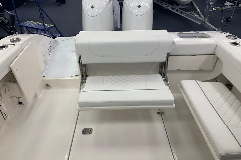 Slide: The Image of 2025 Pursuit DC 266 Dual Console boat interior with white seating and modern design. - 24