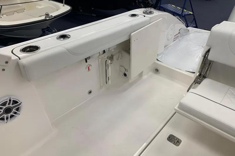 Slide: The Image of 2025 Pursuit DC 266 Dual Console boat interior with seating and storage compartments. - 25