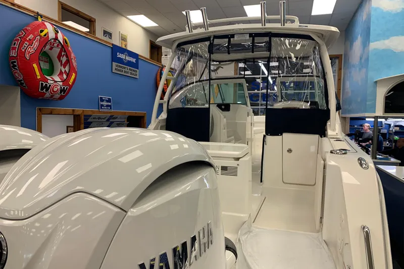 Slide: The Image of 2025 Pursuit DC 266 Dual Console boat displayed indoors with Yamaha engines. - 5