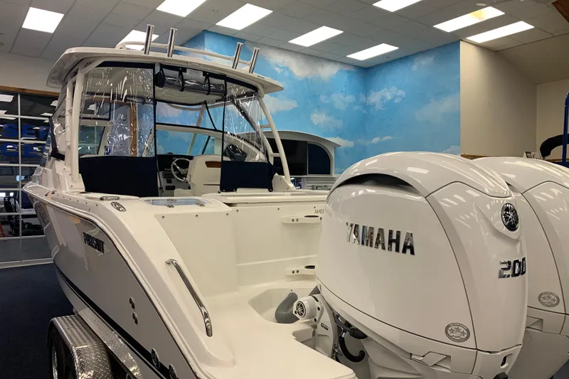 Slide: The Image of 2025 Pursuit DC 266 Dual Console boat with Yamaha 200 engines in showroom. - 7