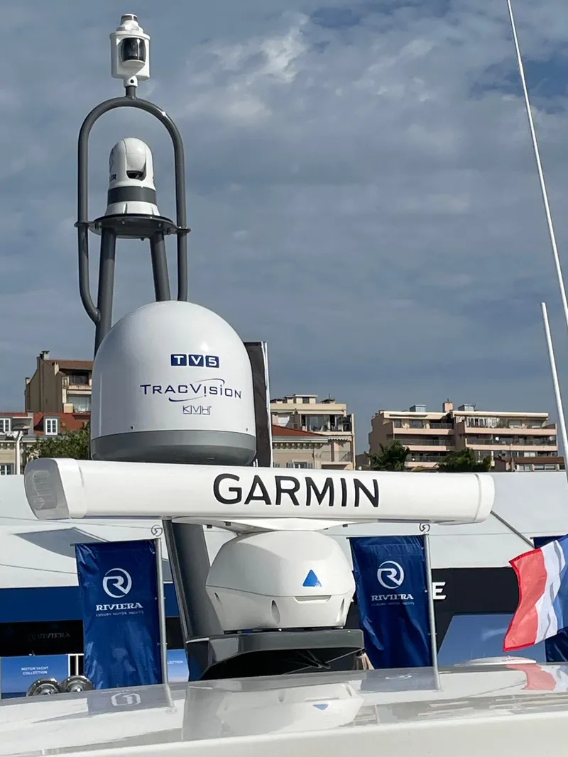 Slide: The Image of Riviera 505 SUV 2022 yacht with Garmin and TracVision equipment, docked under a cloudy sky. - 51