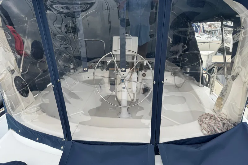 Slide: The Image of 1999 Hunter Passage 420 sailboat cockpit with steering wheel and protective cover. - 15