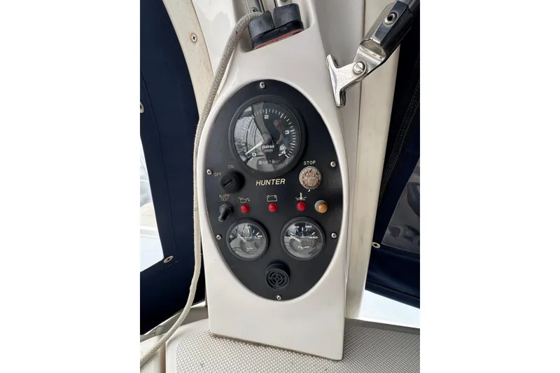 Slide: The Image of Control panel of a 1999 Hunter Passage 420 sailboat, featuring gauges and switches. - 18