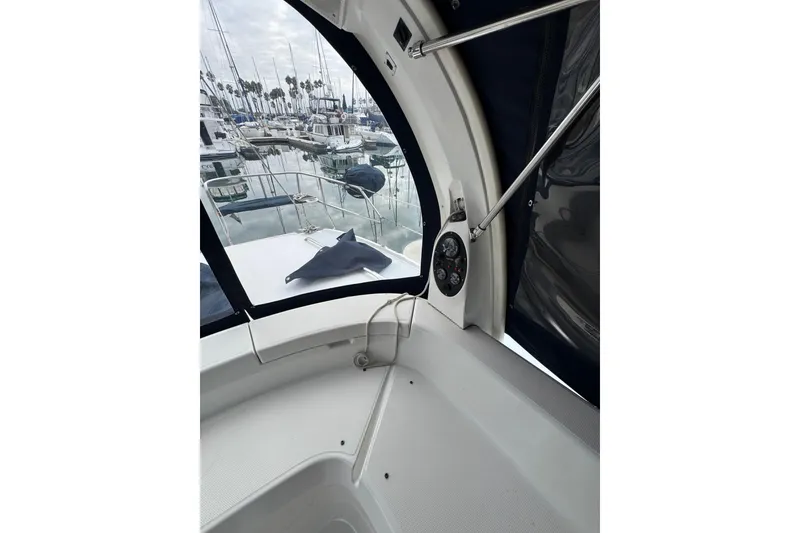 Slide: The Image of Interior view of 1999 Hunter Passage 420 sailboat cockpit with marina background. - 19