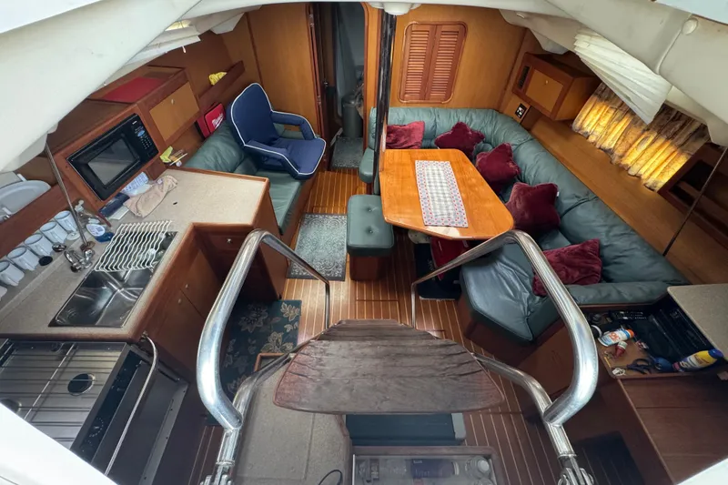 Slide: The Image of Interior of 1999 Hunter Passage 420 yacht with cozy seating and kitchen area. - 24
